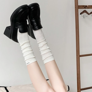 White ribbed slouch socks with black platform loafers and stayloose label details