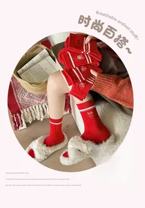 Close-up of red cotton crew socks with white stripes and embroidered smiley face detail