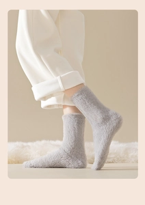 Detail of plush faux mink fur socks in light grey for winter warmth and comfort