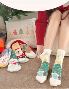 Detail of soft coral fleece Christmas socks featuring Santa Claus and snowman patterns