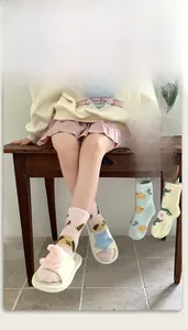 Close-up of thick coral fleece winter socks with star patches and soft plush texture