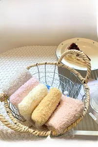 Close-up of five colorful thick coral fleece socks neatly folded in a wire basket