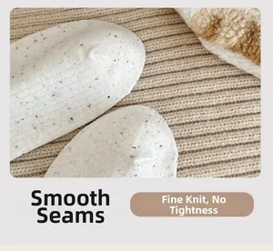 Detail of smooth toe seam and fine knit texture on white polka dot cotton socks