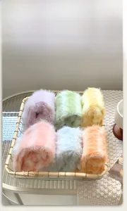 Detail of plush fuzzy socks in macaron colors displayed in a decorative metal basket