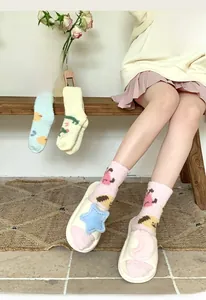 Detail of coral fleece warm socks with cartoon patterns and plush home slippers set