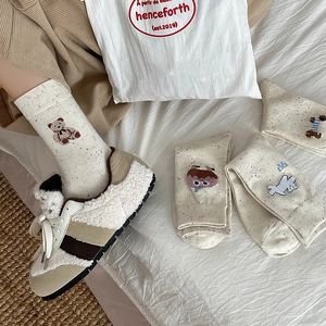 Cozy oatmeal beige crew socks with cute cartoon embroidery and fleece sneakers