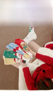 Detailed view of thick Christmas coral fleece socks with festive holiday patterns