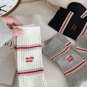 Three pairs of ribbed knit crew socks in black, white and grey with red mucho amor embroidery