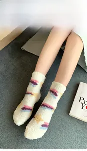 Close-up of thick coral fleece star pattern socks for winter home comfort and warmth