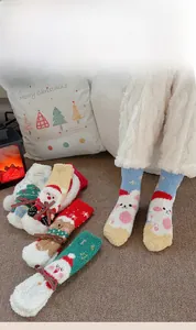 Close-up of thick coral fleece fabric texture on festive Christmas themed crew socks