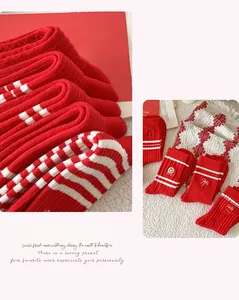 Detailed macro view of red and white striped cotton socks with bow and smile embroidery