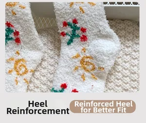 Detail of reinforced heel on white coral fleece socks with yellow sun embroidery