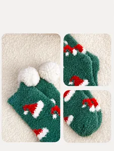 Detail of plush green Christmas socks with red hat patterns and white decorative pom-poms