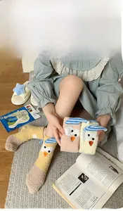 Detail showing plush coral fleece texture and cartoon owl design on warm winter socks