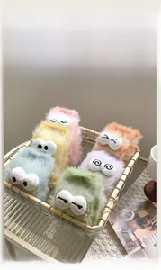 Detail of colorful fuzzy socks with cartoon 3D eyes in a metal basket for cozy home wear