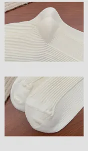 Detailed close-up of seamless reinforced heel and toe on cream ribbed knit socks