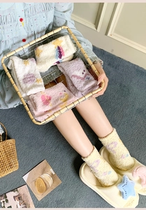 Detail of coral fleece thick socks with star patterns in various soft pastel colors