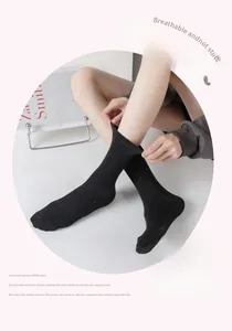 Close-up of black speckled knit socks showing ankle stretch and cotton texture