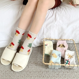 Thick coral fleece thermal socks for women with cute cartoon patterns in a cozy home setting