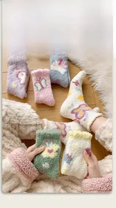 Detailed texture of thick coral fleece socks with colorful cartoon butterfly patterns