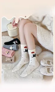 Detail of soft cotton crew socks with cute cartoon animal embroidery and turn-up cuffs