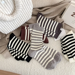 Striped cotton crew socks set in various colors on cozy white fleece background