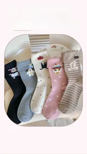 Detail of five pairs of cotton crew socks with cute cartoon embroidery and rolled cuffs