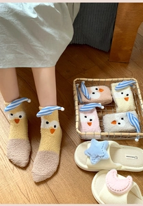 Detailed view of thick coral fleece winter socks with cartoon chick embroidery