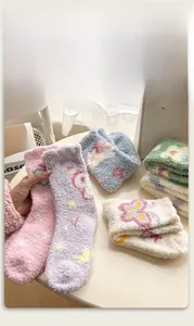 Detailed view of thick coral fleece winter socks with colorful cartoon jacquard patterns