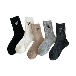 Five pack of thick wool blend crew socks with embroidered bows in neutral winter colors