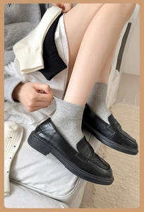 Detailed close-up showing the high elasticity of cotton crew socks with black loafers