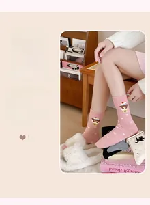 Close-up of pink cotton socks featuring cute bear patterns and white bow designs