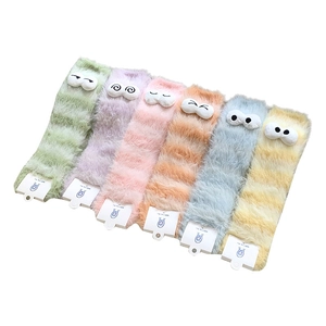 Fuzzy cartoon socks in macaron colors with funny eyes and warm thick plush texture