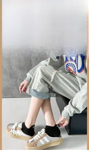 Close-up of beige platform sneakers and black cotton ankle socks for a casual outfit