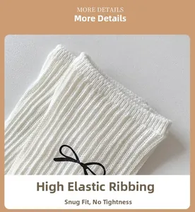 Detail of high-elasticity ribbed cuff on white cotton sock with black bow pattern