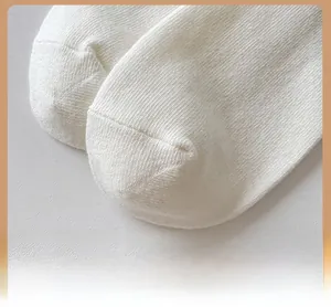 Detail of reinforced toe on white cotton calf socks with high-density knit texture