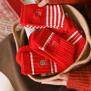 Festive red striped cotton mid-tube socks with smile embroidery in a gift basket