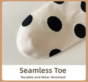 Close-up of beige polka dot cotton socks featuring boneless toe seam and durable knit