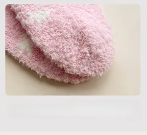 Close-up of pink coral fleece socks showing flat toe seam and soft fuzzy texture