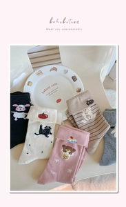 Detail of cotton crew socks featuring animal embroidery and cute cuffed designs