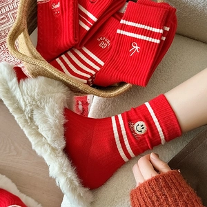 Festive red crew socks with cartoon smile embroidery and stylish stripes in soft combed cotton