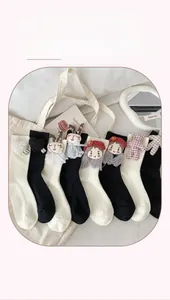 Detail of cotton crew socks featuring cute 3D cartoon patches and striped texture