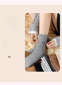 Detail of soft cotton crew socks with bow embroidery and vertical ribbed knit texture
