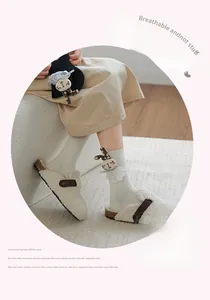 Detail of white cotton rib socks with cute plush rabbit doll and lace trim detail