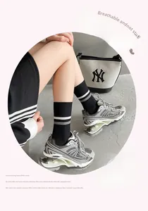 Detail of breathable striped cotton crew socks worn with casual sneakers and canvas bag
