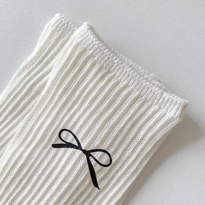 White ribbed cotton calf socks with black bow patterns for women in a minimalist style