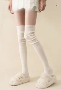 Detail of off-white thigh-high slouch socks in soft cotton knit for women
