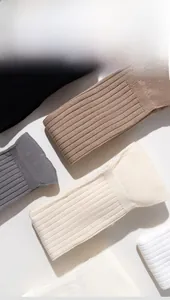 Detailed view of ribbed knit texture on multi-color thigh high cotton socks for women
