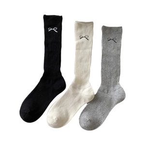 Knit cotton crew socks in white, black, and grey with cute bow tie embroidery detail