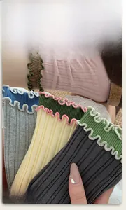 Close-up of ribbed cotton socks with double ruffle edges in assorted color combinations